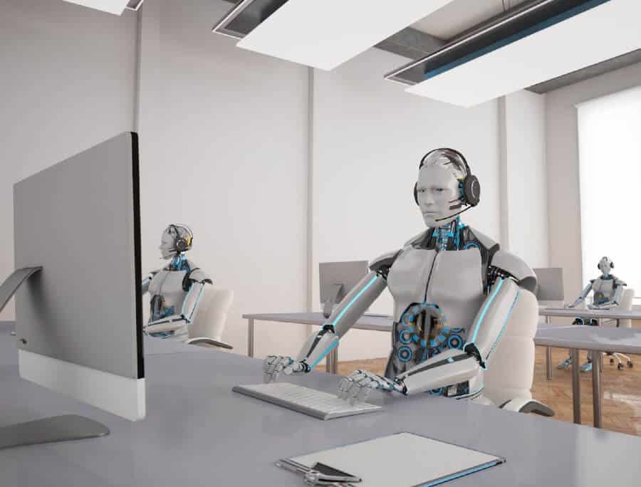 Robots working at desks with computers in modern office, showcasing futuristic AI technology for digital marketing solutions.