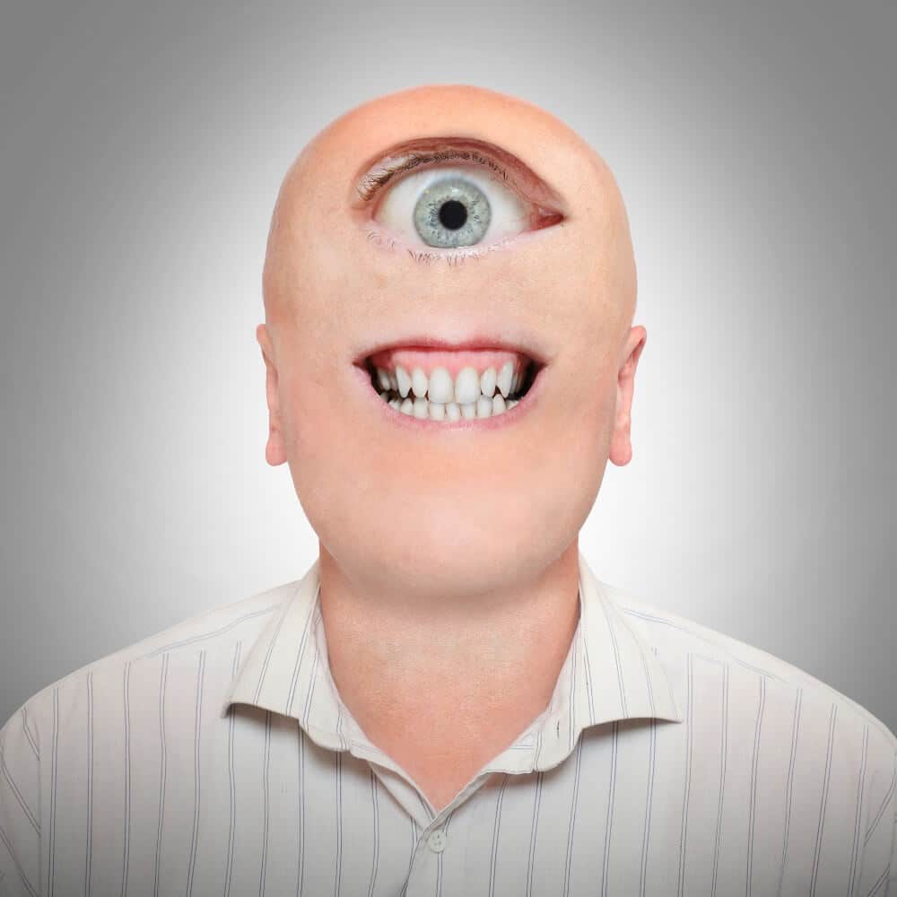 Bald man in striped white shirt on gray background, Make It Loud Digital Marketing branding profile.