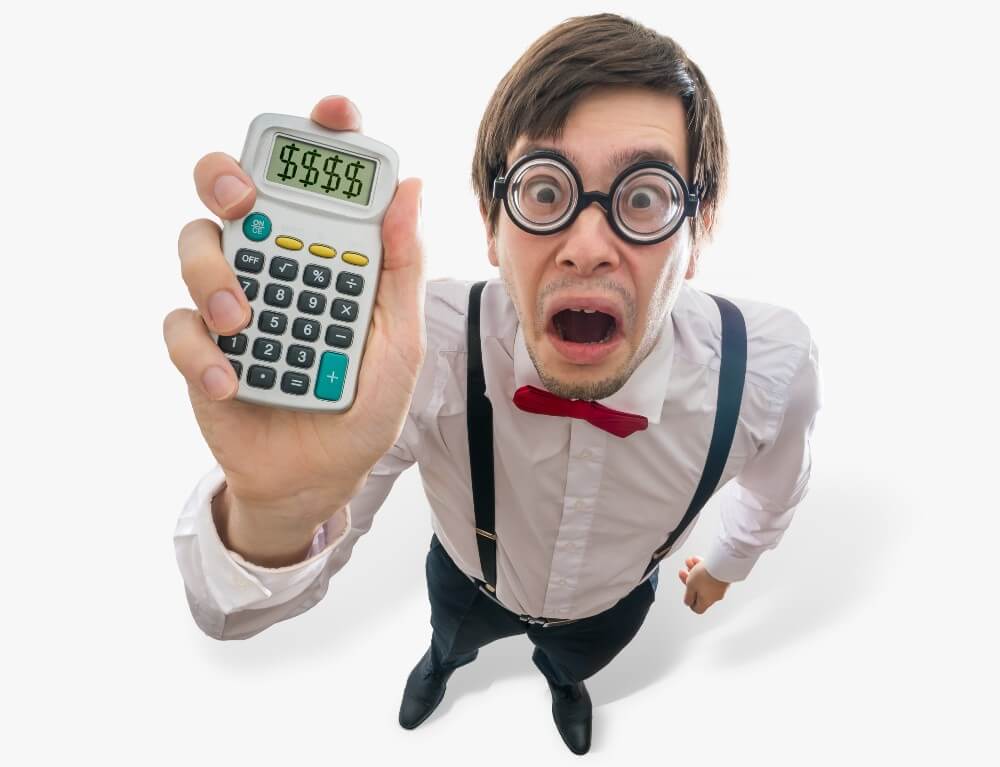 Man in white shirt, red bow tie, and suspenders holding a calculator with dollar signs on screen, representing digital marketing ROI.