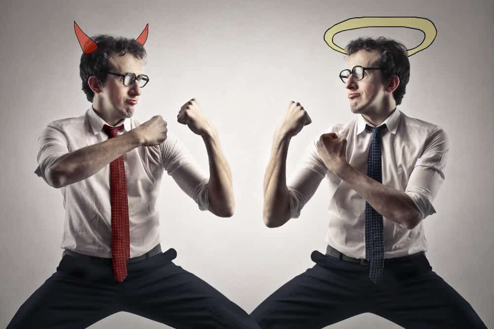 Man in business attire with devil horns facing himself with a halo, symbolizing digital marketing strategy decisions.