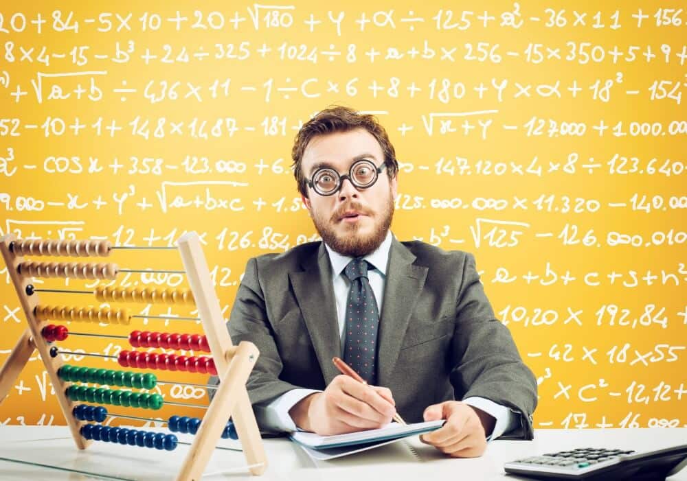 Businessman in gray suit writing on papers, colorful abacus, math equations on yellow board, digital marketing strategy brainstorm.